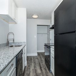All-electric kitchen with black appliances and white cabinets in one bedroom apartment at Stone Canyon Apartments, located in Colorado Springs, CO