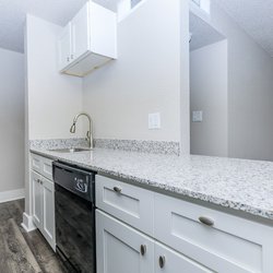 Kitchen with breakfast bar and all-electric appliances at Stone Canyon Apartments, located in Colorado Springs, CO