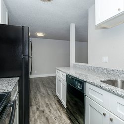 All-electric kitchen with black appliances and white cabinets in one bedroom apartmentat Stone Canyon Apartments, located in Colorado Springs, CO