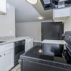 Kitchen with breakfast bar and all-electric appliances at Stone Canyon Apartments, located in Colorado Springs, CO 2