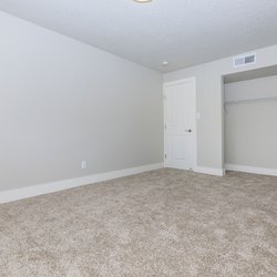 Secondary carpeted bedroom with closet at Stone Canyon Apartments, located in Colorado Springs, CO